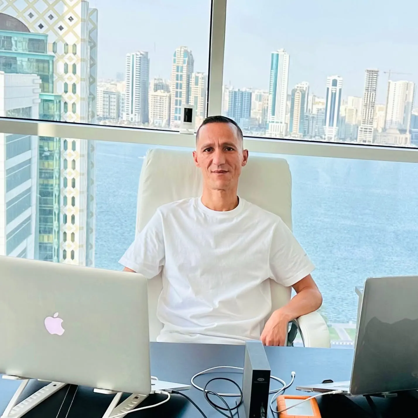 The founder working between two laptops, Sharjah